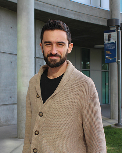 A photo of Juan Rubio in front of Humanities Gateway