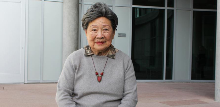 Teresa Chun sits on a bench at the Humanities Gateway courtyard