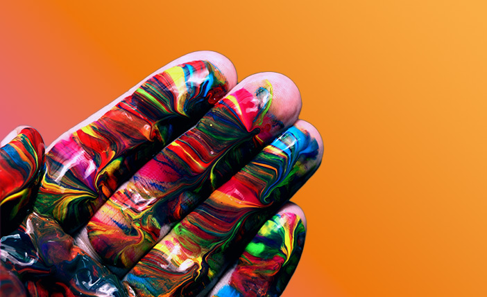 Fingertips covered in rainbow and psychedelic colors