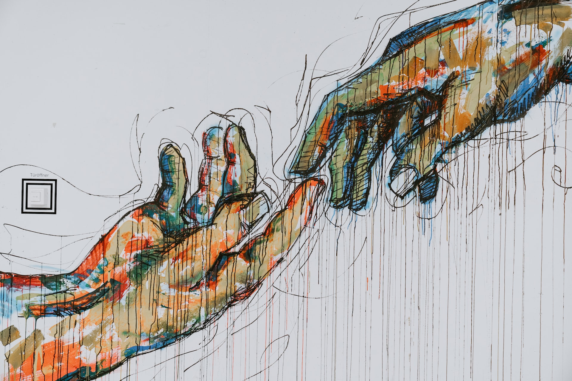 Painting of two hands barely touching by the fingertips
