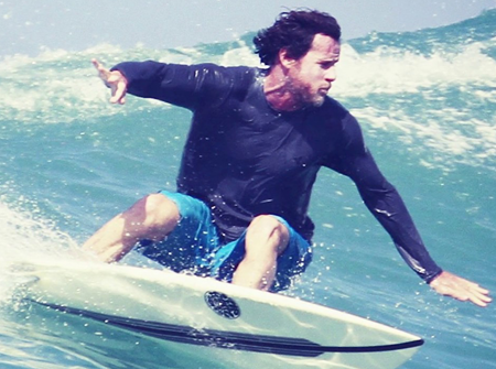 Professor Aaron James surfing 