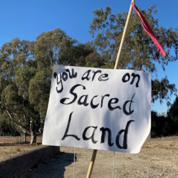 Protest poster in Long Beach that says "you are on sacred land"