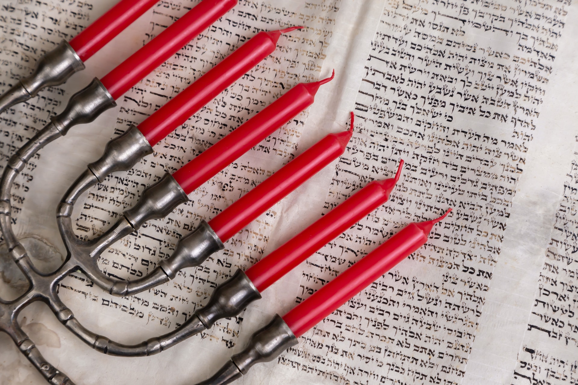 Red candles and hebrew text