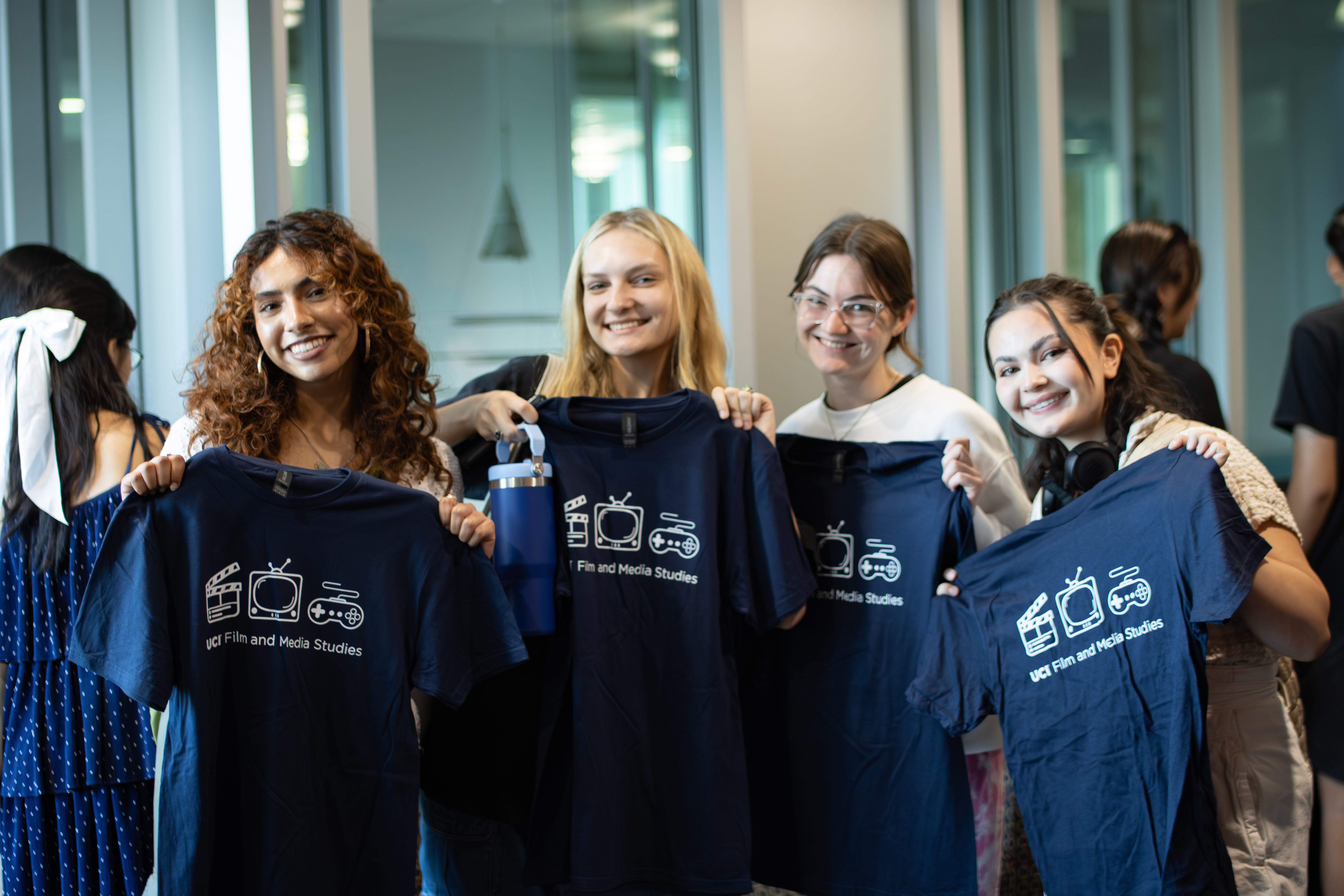 Students holding T shirts