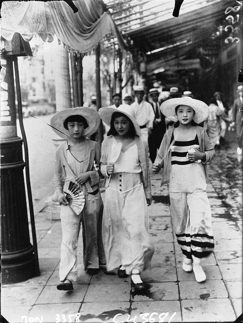 Modern girls wearing "Beach Pajama" style clothing walking down Ginza in 1928