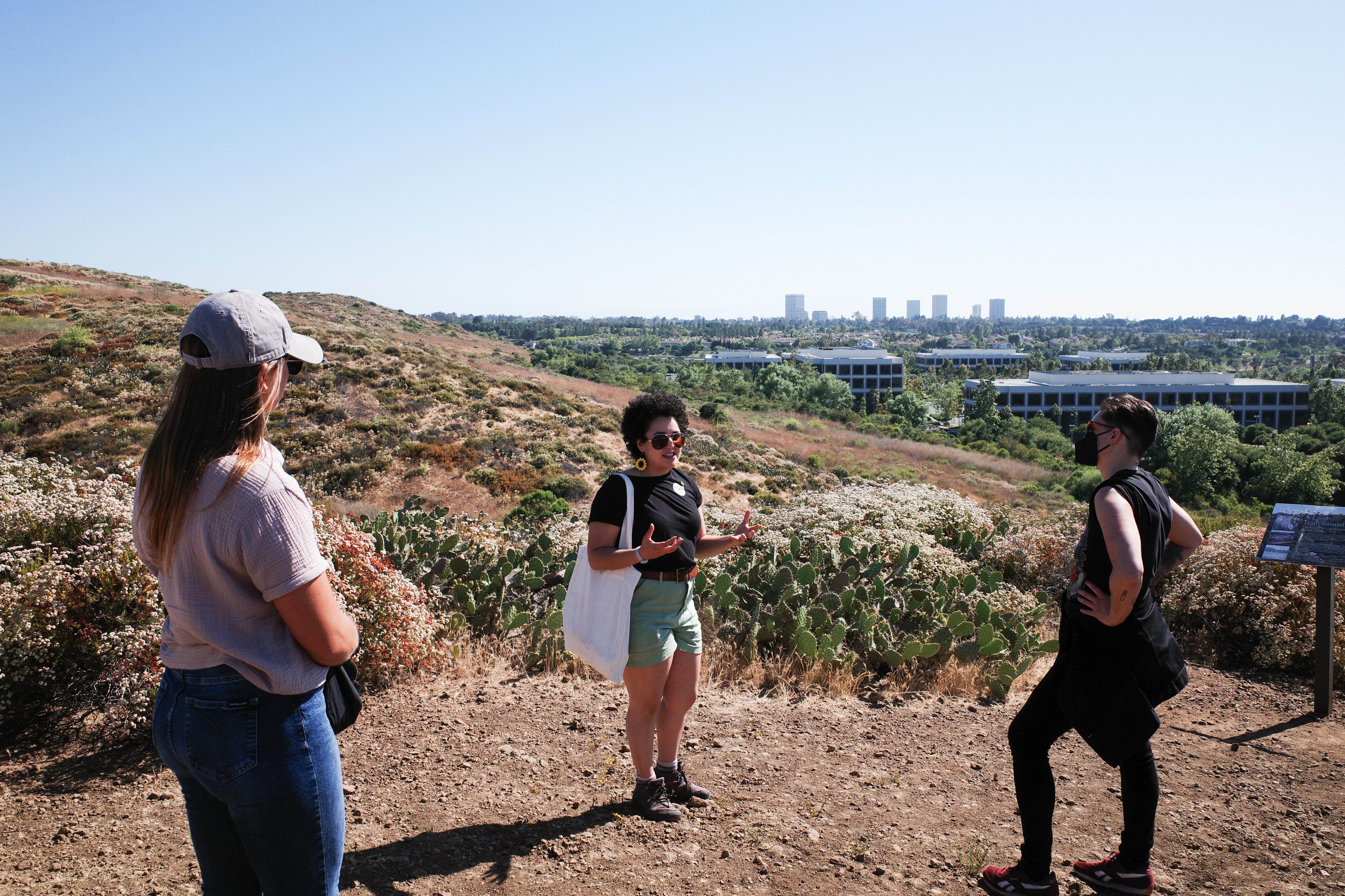 Samantha Morales Johnson Yang discusses native and non-native grasses near the top of the UC Irvine Ecological Preserve.