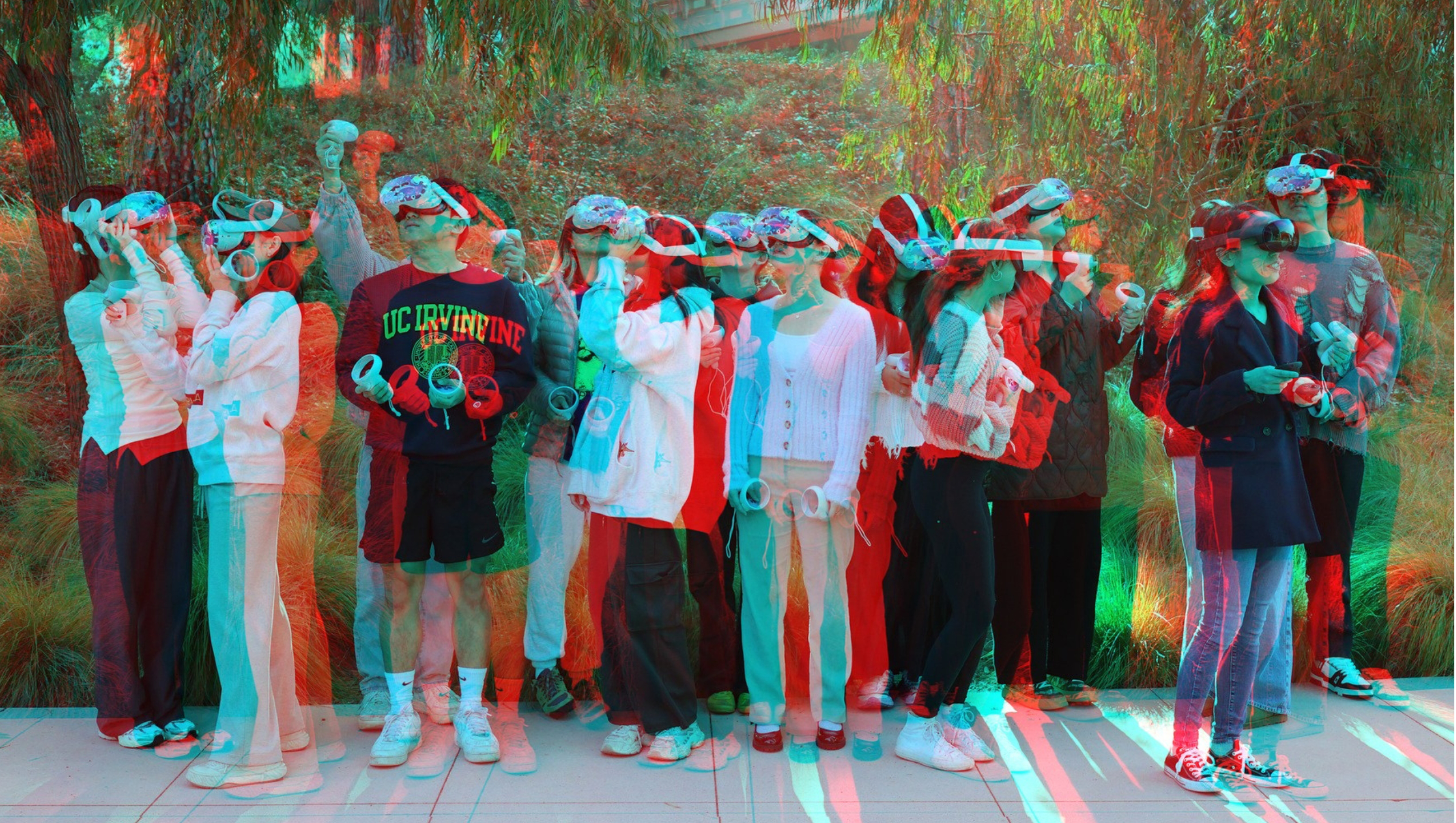 intentionally blurry photo of students standing in a group on campus wearing VR headsets