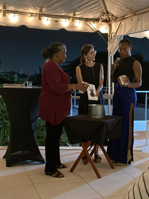 Offshore Attachments was baptized with soil from the island by the “godmothers” of the book, poet Nifa Ansano (right) and scholar of gender and sexuality Jacqueline (Jackie) Martis (left).