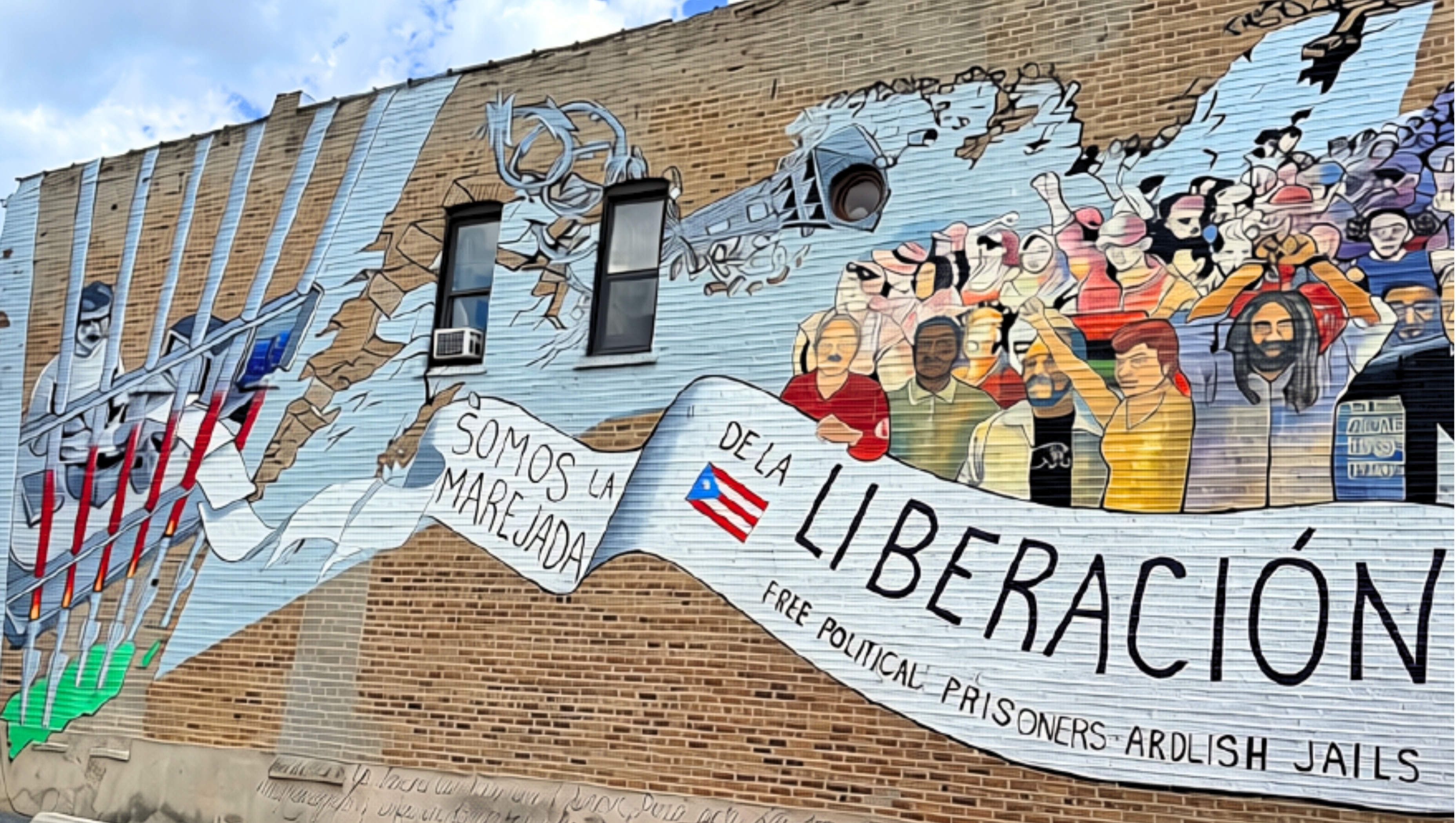 Mural painted on Division Street in the historic Paseo Boricua neighborhood of Humboldt Park, Chicago that reads "Oscar, somos la marejada de la liberación" ("Oscar, We Are the Groundswell of Liberation")