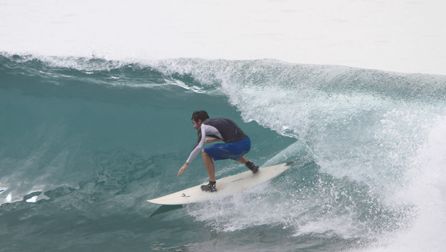 Aaron James surfing a wave