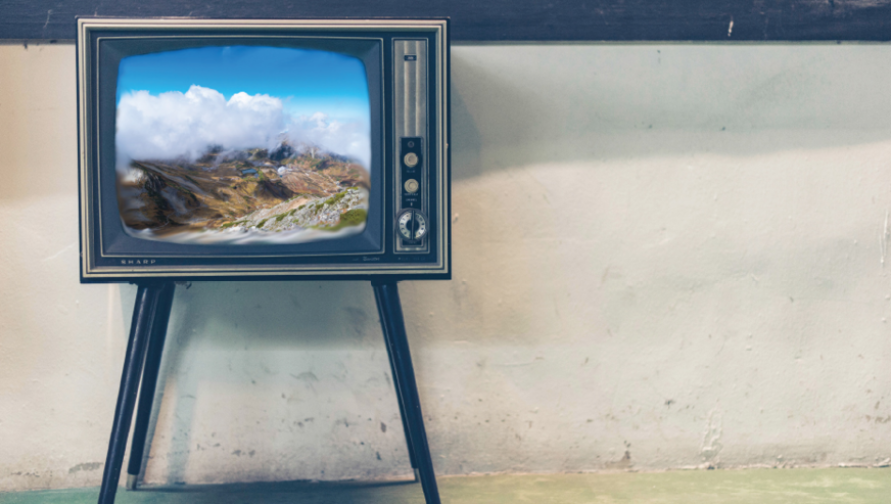 A retro television displays a landscape shot of a mountainous region