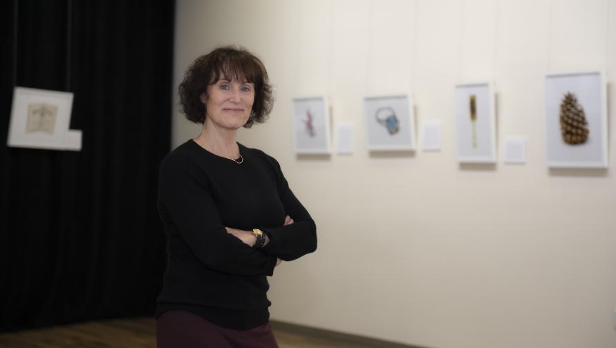 A photo of Lorene Delany-Ullman standing in an art exhibit