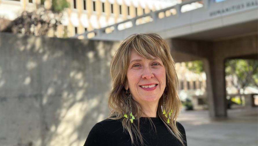 Kelly Brown is outside Murray Krieger Hall and she's smiling