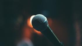 A microphone against a dark backdrop
