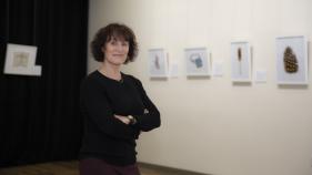 A photo of Lorene Delany-Ullman standing in an art exhibit