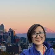Connie Griffith smiling in front of a city background during sunset