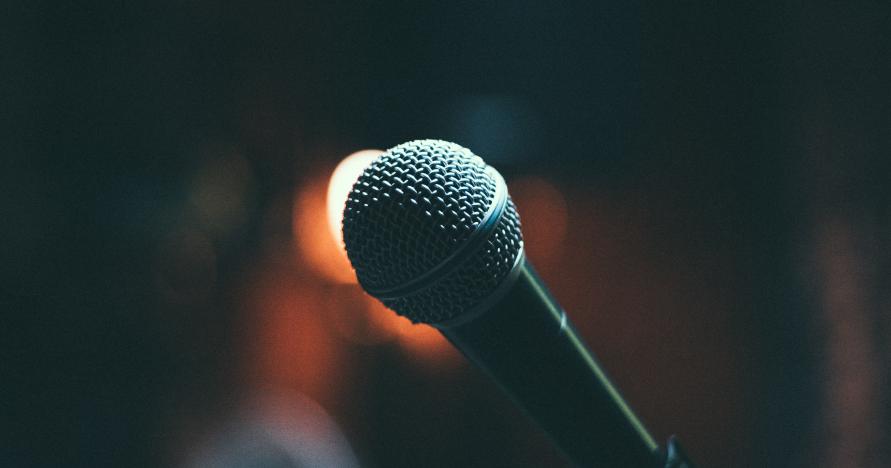 A microphone against a dark backdrop