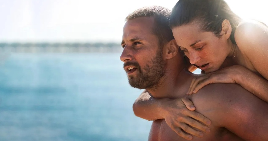 A woman holding onto the back of a man