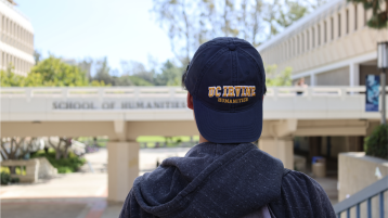 Student in front of Humanities Gateway