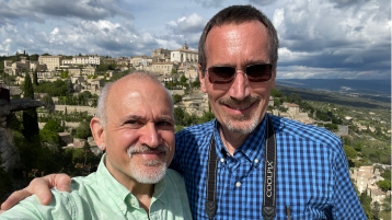 A photo of John Dumas (B.A. English ‘94) and UCI Professor James Nowick with a scenic background. 