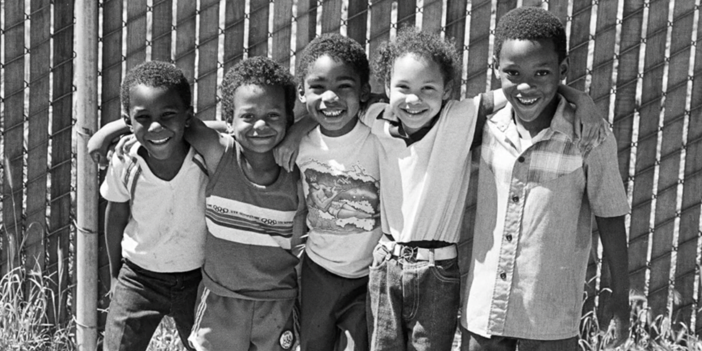 A group of young students smile for the camera. 