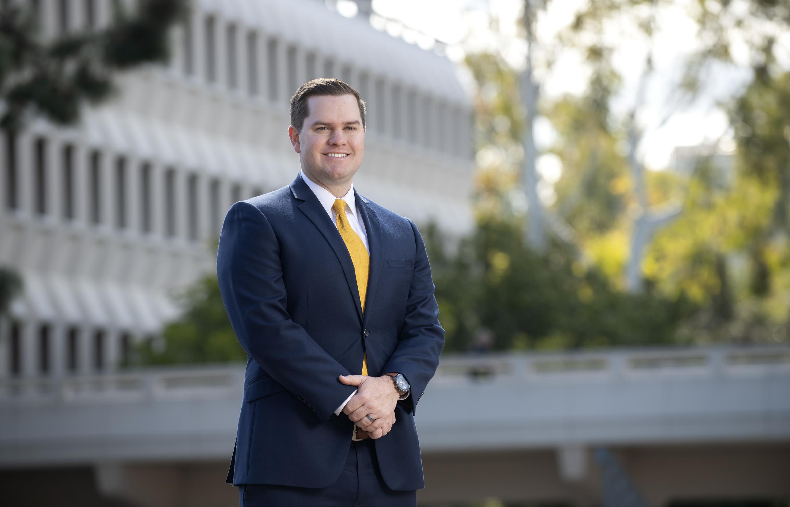 Ian Massey standing in front of a building