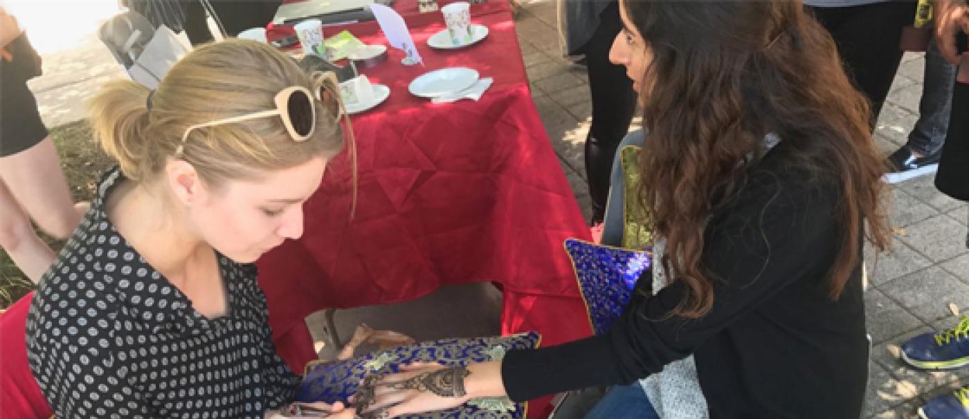 Girl getting henna on her hand