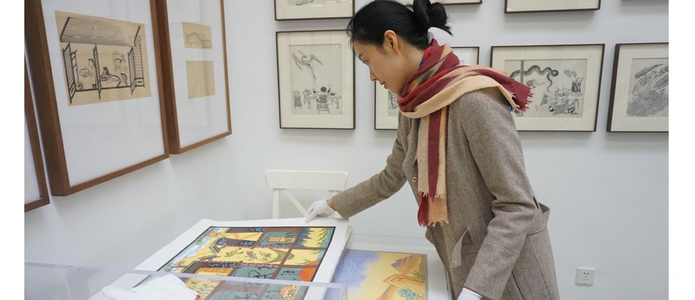 Yuan looking at a piece of art