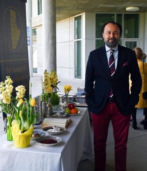 Professor Daryaee standing in front of the Center for Persian Studies Haft-sin table