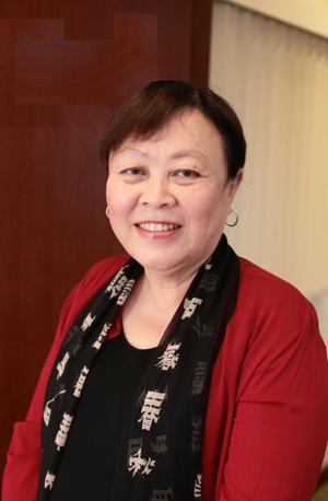 Headshot of woman wearing red cardigan and black top