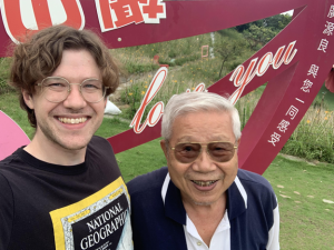 Nathaniel standing next to Taiwanese ping pong coach