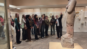 Students look up at a huge sculpture.