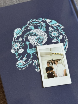 Loris, Amir, and another intern are pictured in a polaroid image with a cool scarf in the background.