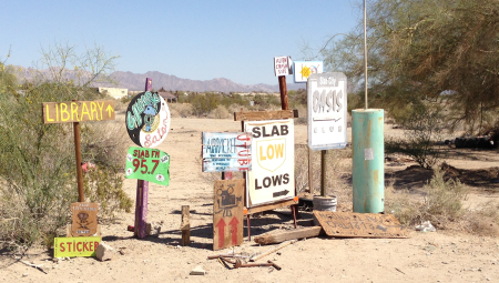 An image of the desert with multiple signs.