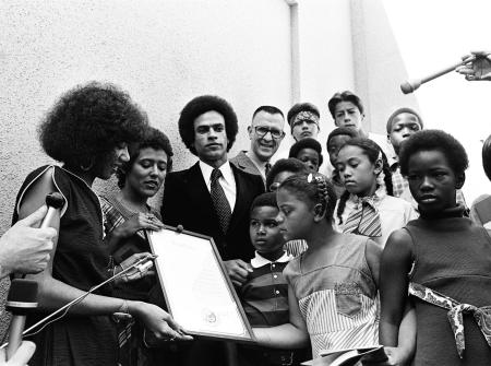 Black and white photo of Huey P. Newton and OCS students in Sacramento