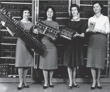 1962 U.S. Army photo with four women positing with one digit of storage from each of four computers